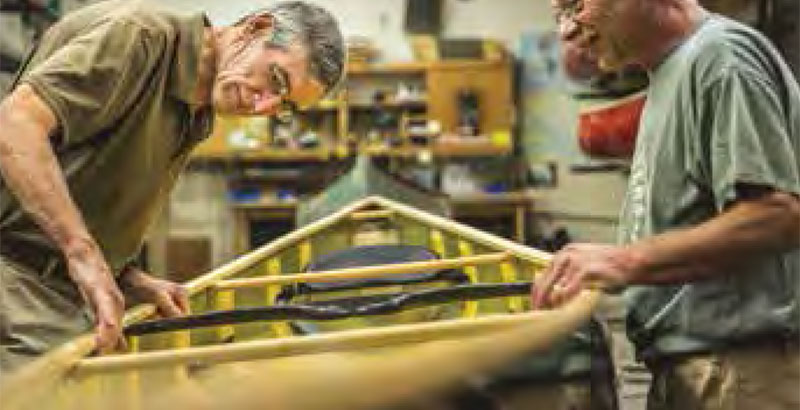 Mike C. inspecting canoe.